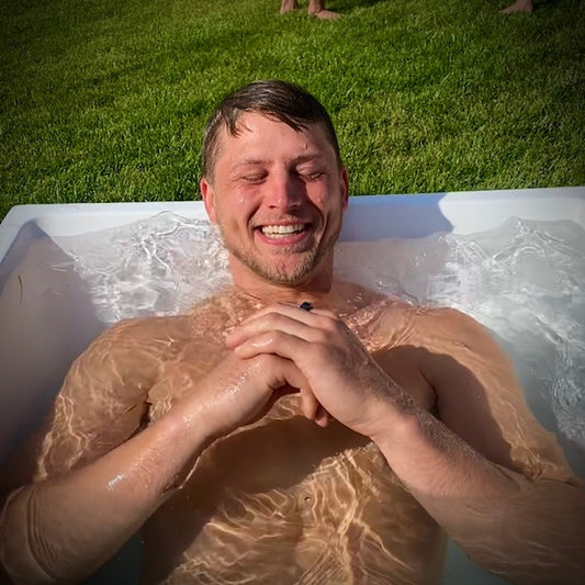 Man smiling in an ice bath