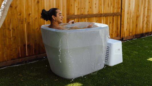 man in cold plunge tub relaxing