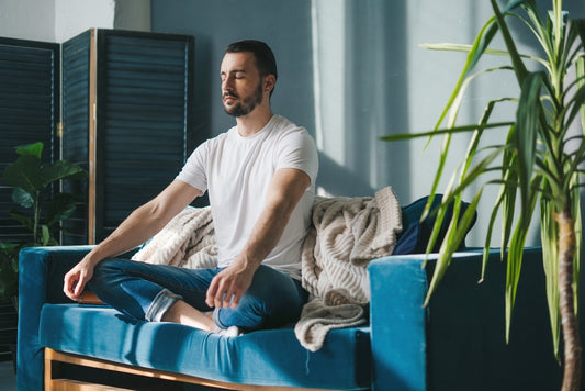 man meditating on his couch