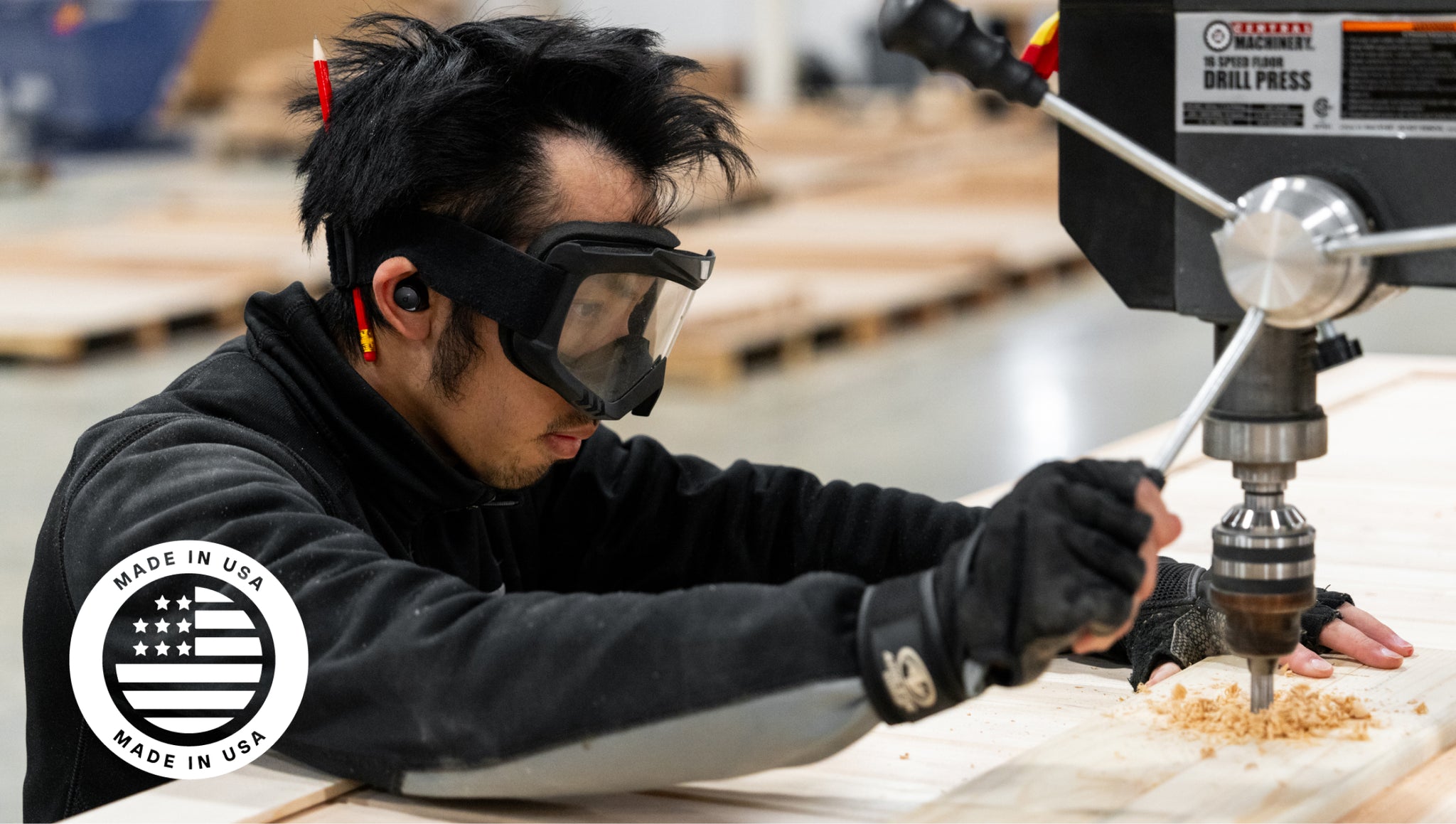 A worker in safety gear assembles The Sauna Mini by Plunge; Made in USA logo displayed.