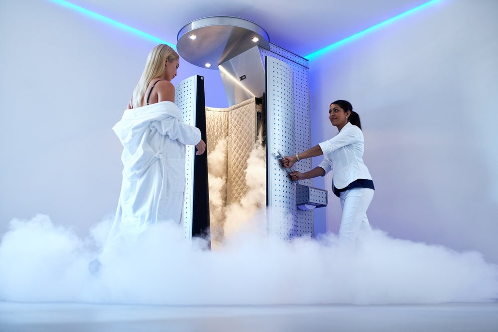 woman entering cryotherapy chamber
