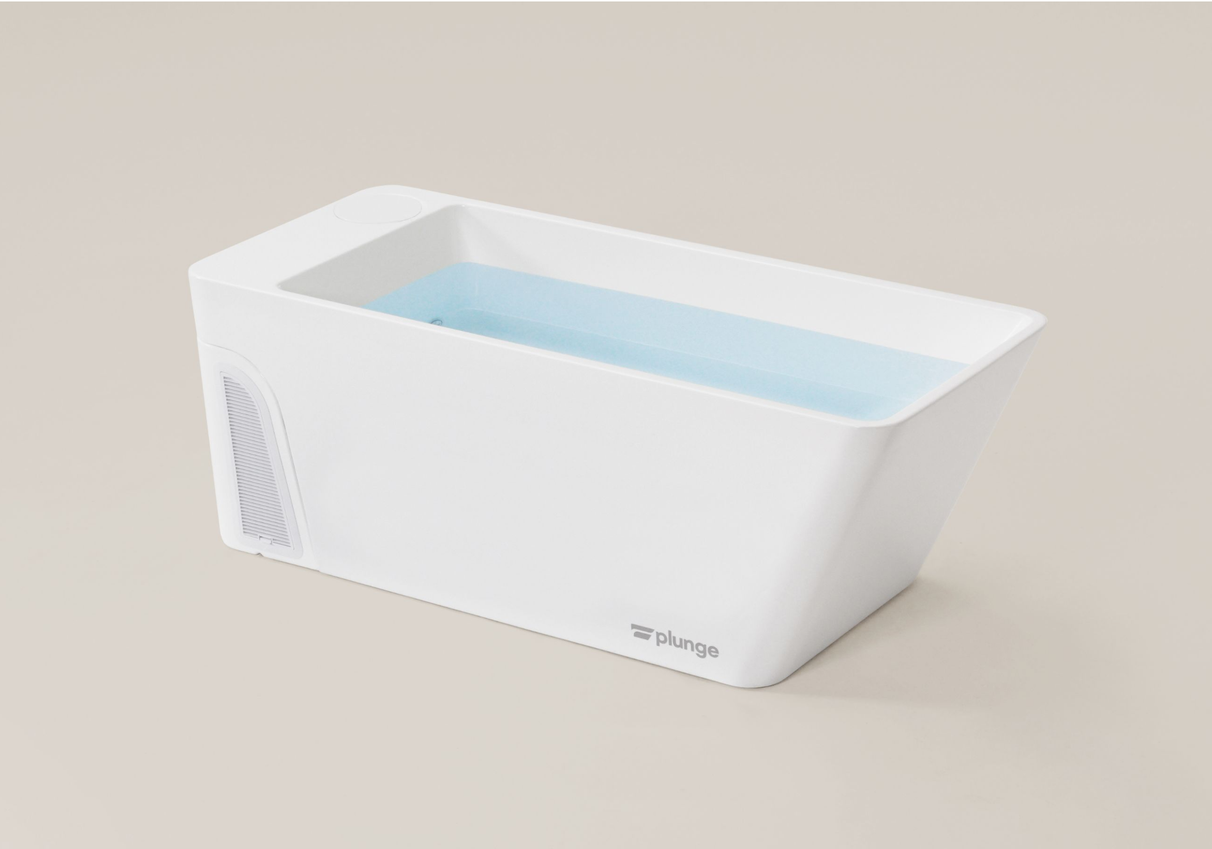Modern white plunge tub filled with light blue water.